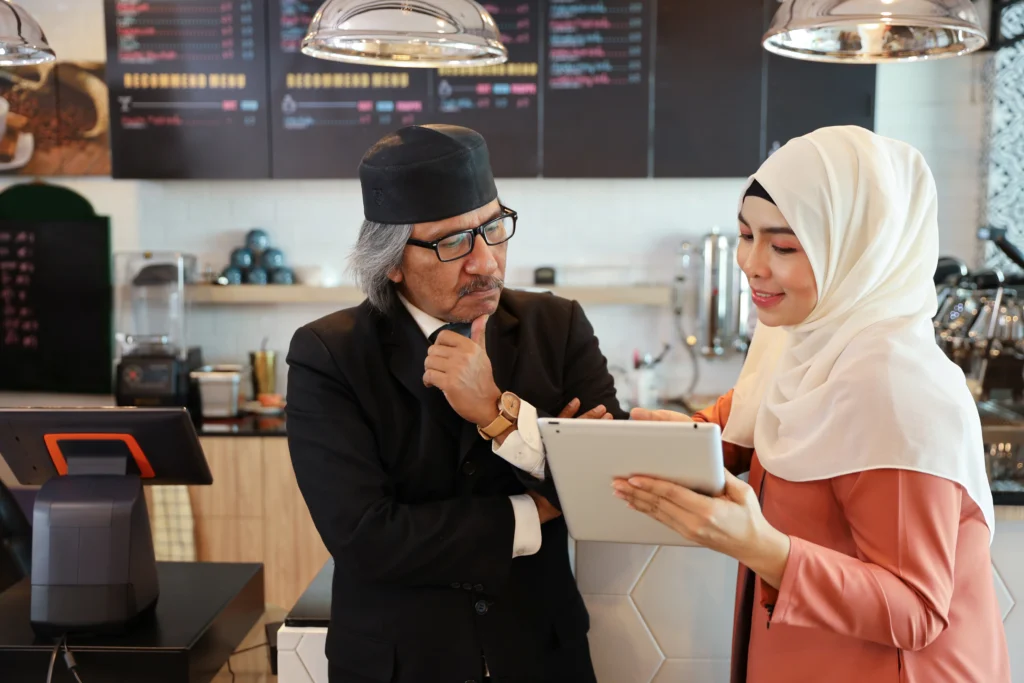 2 malaysian colleagues discussing a report