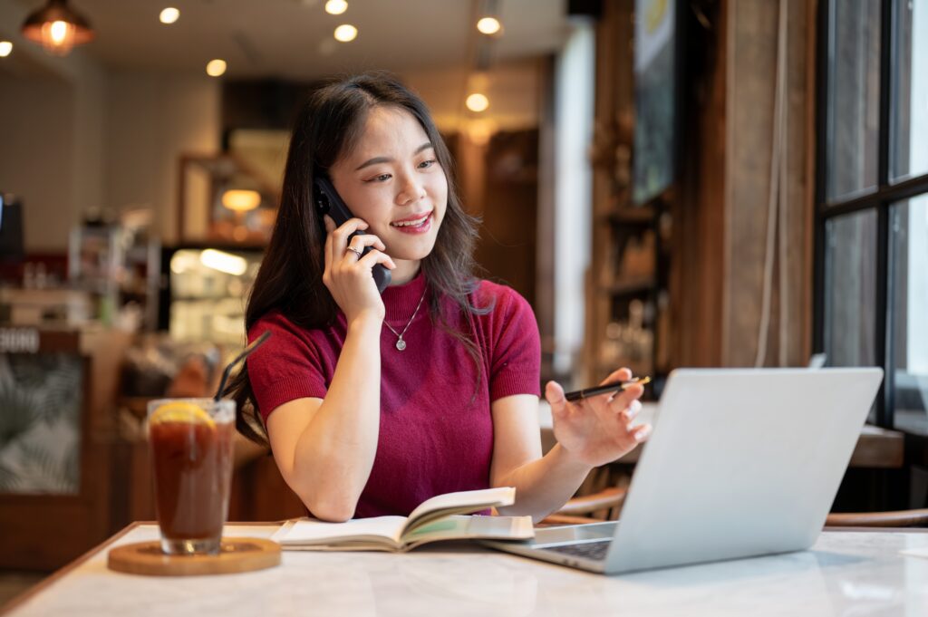 An SME owner making a vetting call to a POS system supplier in Malaysia at a café.